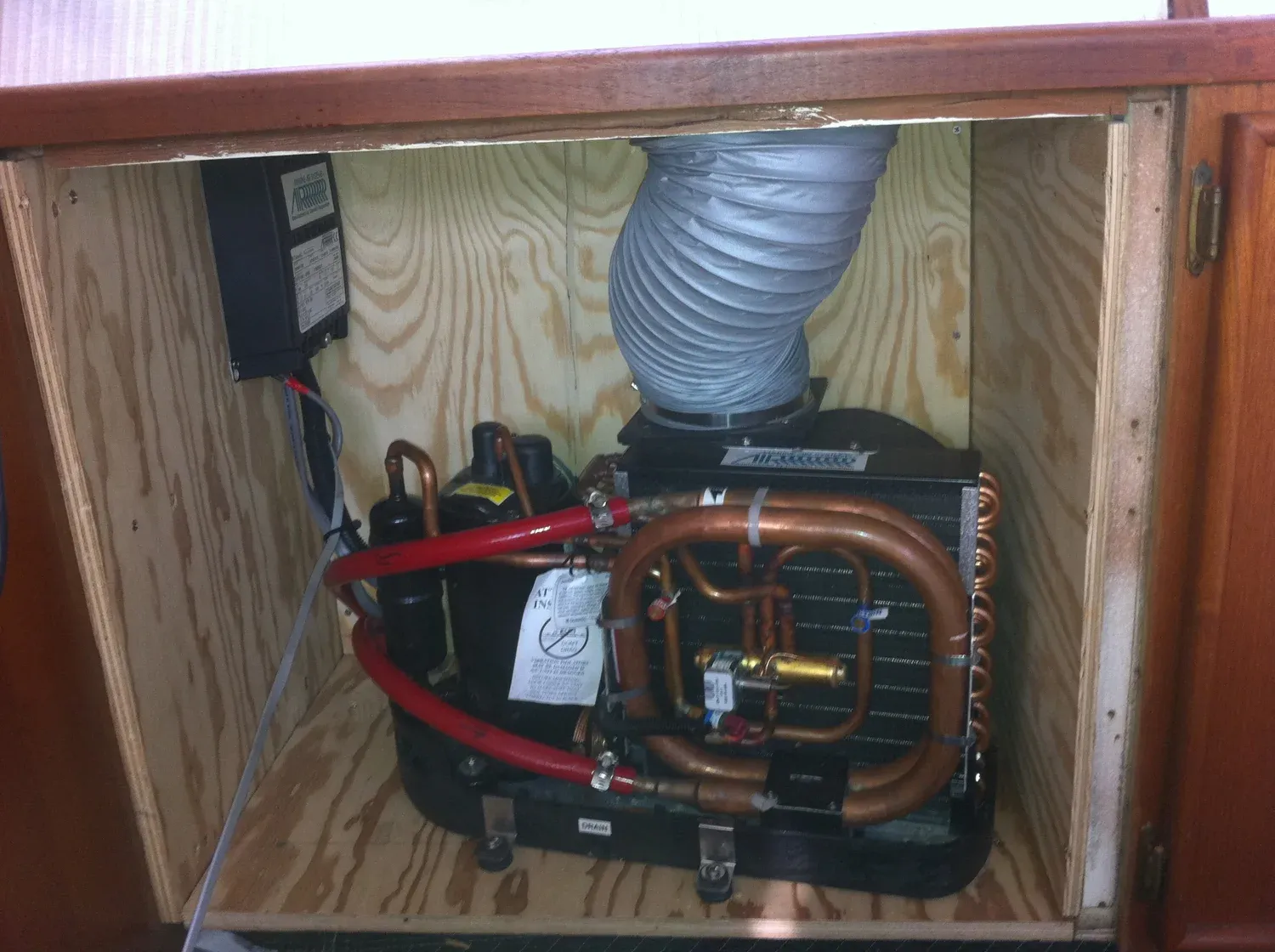 Diesel cabin heater fitted inside varnished cabinetry
